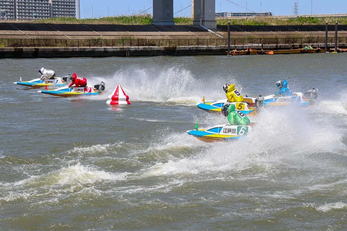 Boat racers piloting motorboats. The first turn area is typically an exciting place to watch the action taking place